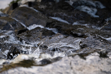 Fast Flowing Water Over Dark Stones