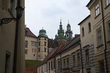 Historic European street with old buildings and church tower. Narrow cobblestone alley with traditional architecture, ideal for travel, tourism, and cultural heritage themes.