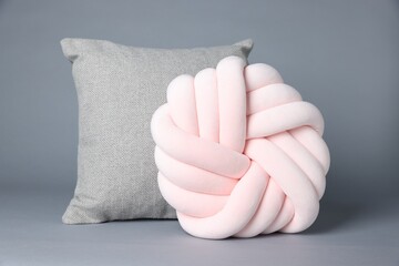 Two soft decorative pillows on grey background