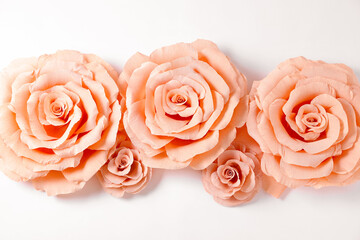 Beautiful pink paper flowers on white background, flat lay