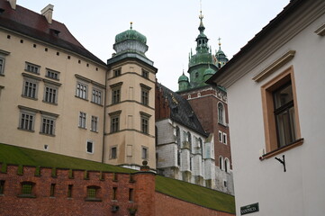 Historic European street with old buildings and church tower. Narrow cobblestone alley with traditional architecture, ideal for travel, tourism, and cultural heritage themes.