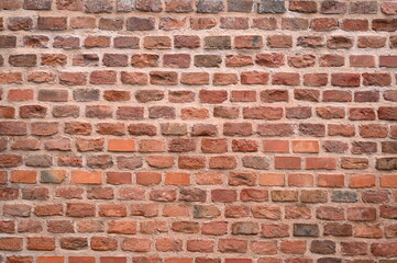 red brick wall texture close-up as background texture of a red brick wall with visible mortar lines and natural wear. ideal as a background for architectural, construction, design, or urban visuals.