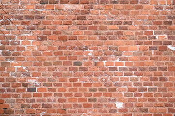 Obraz premium red brick wall texture close-up as background texture of a red brick wall with visible mortar lines and natural wear. ideal as a background for architectural, construction, design, or urban visuals.