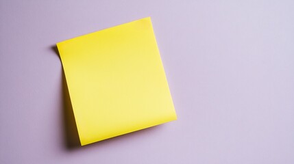 Yellow sticky note with hand drawn borders stuck to a soft lavender background for a playful creative design