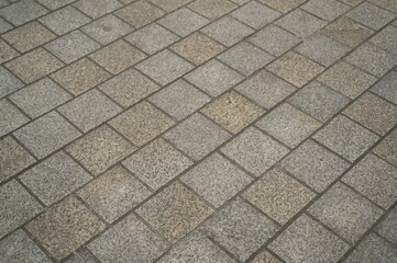 grey stone pavement with square tiles forming a geometric pattern