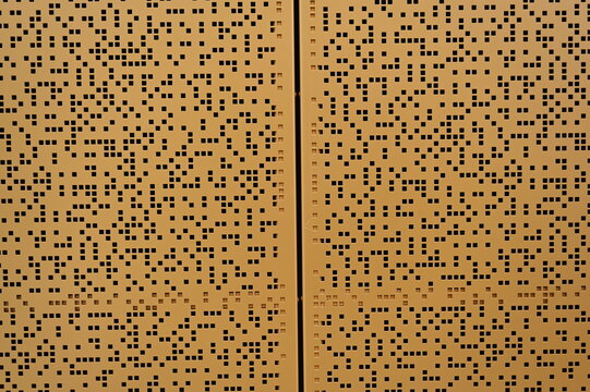 Modern perforated metal wall pattern and outdoor city clock in Luxembourg Geometric perforated metal panels with square cutouts forming a modern wall design. Outdoor city clock tower  - Powered by Adobe