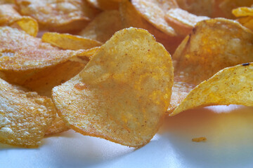 Potato chips on the table. Macro. Horizontal shot.