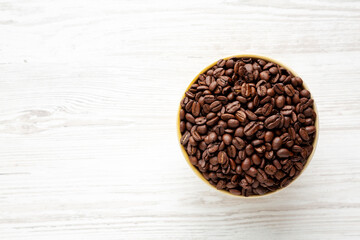 Organic Roasted Coffee Beans in a Bowl, top view. Copy space.