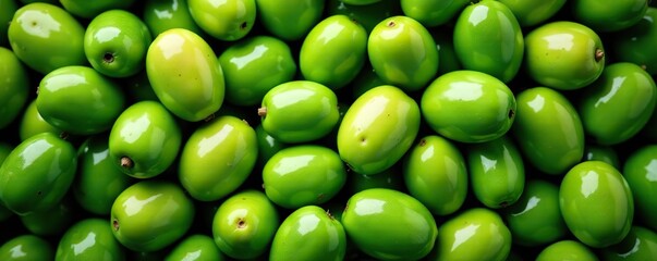 Top view of full frame background of many green fresh olives scattered at plant,  agriculture,  Mediterranean