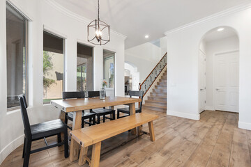 A dining room with a table, chairs, and a comfy bench