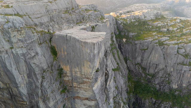 Aerial view of majestic Preikestolen cliff with rugged rock formations and dramatic elevation, Preikestolen, Norway. No people on the rock.