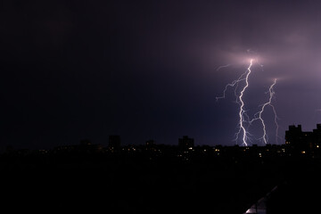 bright lightning in the night sky over the city