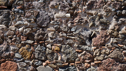 Volcanic stones wall texture background close up.