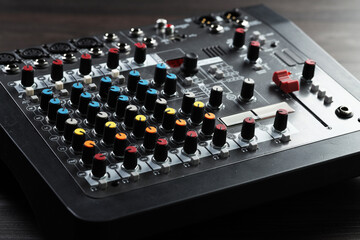 Professional mixing console on table, closeup. Radio studio equipment