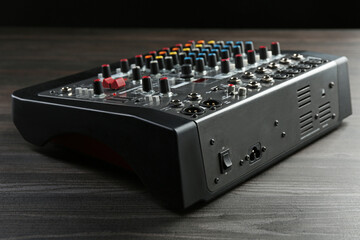 Professional mixing console on wooden table, closeup