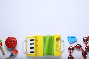 Flat lay composition with different toy musical instruments on white background. Space for text