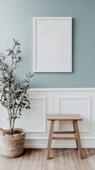 Minimalist Living: A serene interior featuring a blank frame, a potted plant, and a wooden stool, bathed in soft, natural light, creating a calming and inviting atmosphere.