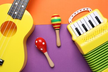 Different toy musical instruments on color background, flat lay