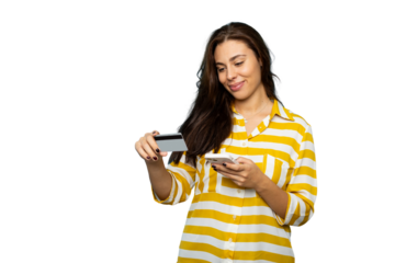 Smiling young woman holding credit card and smartphone, making secure online payment on transparent background