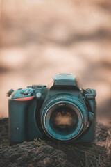 Digital camera with an antique lens on the lawn of a beautiful forest, world photography day concept, copy space.