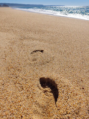 Footprints in the sand leading to the ocean symbolize journeys, paths, and solitude. Perfect for travel blogs, wellness articles, or introspective projects.