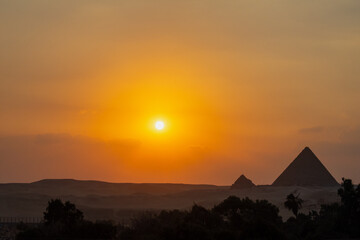 Beautiful colourful sunset over Great Pyramids complex, pyramid of Khafre and Menkaure in Giza, Egypt.