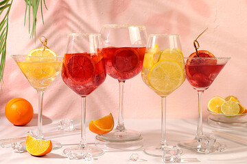 Banner with various glasses of alcoholic drinks and tropical fruits. Cocktails from fruits, ice cubes, rum and tequila. Summer party and relaxation concept. Menu for a bar or cafe