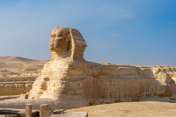 Great Sphinx and Great Pyramid of Cheops, Cairo, Egypt. Ancient statue of Sphinx, mythical creature with head of man and body of a lion, Giza pyramid complex (Giza Necropolis)