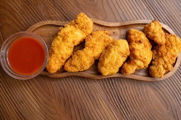 fried chicken in a glass bowl and ketchup