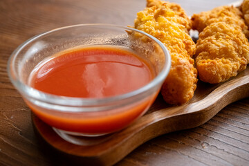 fried chicken in a glass bowl and ketchup