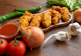 fried chicken in a glass bowl and ketchup