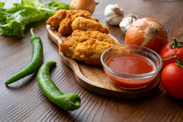fried chicken in a glass bowl and ketchup