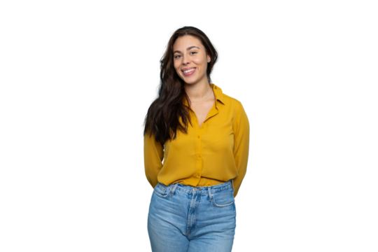 Young woman smiling confidently, standing with hands clasped behind back, studio headshot against transparent backdrop