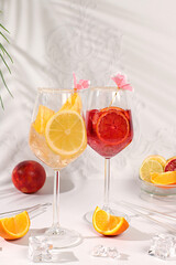 Aperol Spritz cocktails with lemon and orange, ice cubes, rum and tequila. Summer party and holiday concept. Banner with alcoholic drinks and tropical fruits. Menu for a bar or cafe