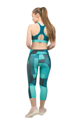 A young slim athletic girl in sportswear performs a set of exercises. Fitness and healthy lifestyle.