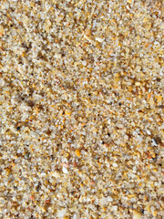 Detailed closeup of beach sand. Texture and patterns perfect for backgrounds, web design, or conveying warmth, relaxation,  natural beauty. Ideal for travel themes.