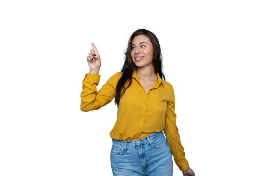 Cheerful woman in studio pointing finger playfully against transparent background, indicating copyspace