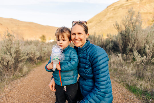 A young toddler enjoys a camping trip with his mother in Oregon.