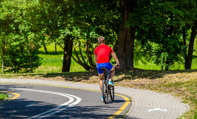 Fototapeta premium Cyclist ride on the bike path in the city Park 