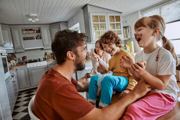 Young family having breakfast in the morning in the kitchen