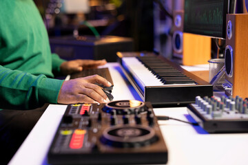 Audio technician working with a professional editing software on pc, mixing and mastering his old...