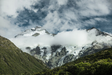 Snowy mountains in the clouds.
