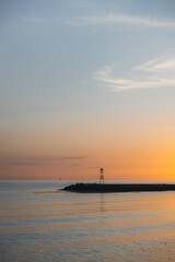 Fototapeta premium A pier in the calm sea at sunset.