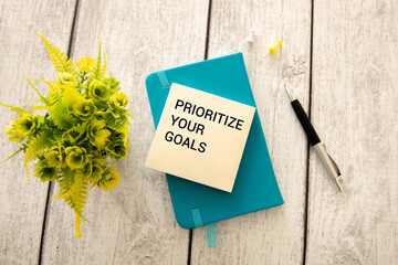 Naklejka premium Priority symbol. Wooden blocks with words 'Prioritize your goals'.