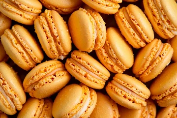 A delightful assortment of orange macarons fills the table, each showcasing a smooth surface and airy texture. The vibrant hue adds a cheerful touch to any festive gathering or event