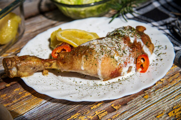 Chicken meat with potatoes and lemon, chicken drumstick with dressing.