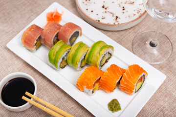 Set of rolls with salmon, avocado, tuna and crab served with soy sauce