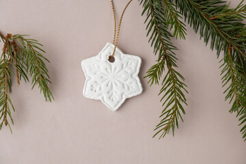 Snowflake White air dry clay for making decor to Christmas tree holiday. Creating hobby recreation activity that involves fingers. DIY crafting Modern art 