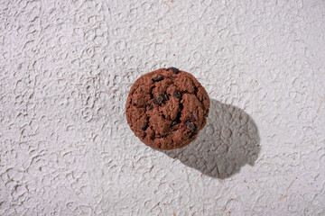 A Single Piece Of Chocolate Chip Cookie With Crumbly Edges, Plated Elegantly For A Perfect Dessert Presentation In Natural Light.