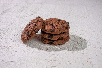 Crispy Chocolate Cookies Arranged In A Vertical Stack On A Bright, Light-Colored Surface Ideal For Cozy Dessert-Themed Visuals.